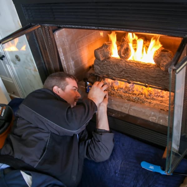 A gas fireplace with flames burning cleanly